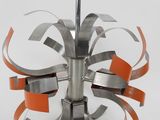 a metal object with orange ribbons on it