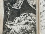 an old book with a picture of a woman sleeping on a bed