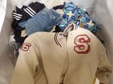 a baseball jacket and other clothing in a plastic bag