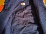 a blue jacket with a carhart logo on it