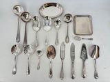 a lot of silver spoons and silverware on the table