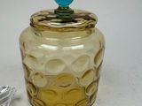 a glass jar with a blue top sitting on a table
