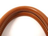 the inside of a brown purse with a leather handle