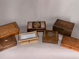 five wooden boxes that are sitting on a white surface