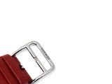 a close up of a red watch strap on a white surface