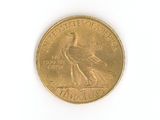 a gold coin with a bird on it on a white surface