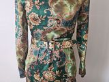 a mannequin mannequin dress with a green and gold floral print