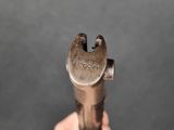 someone is holding a wrenet in their hand on a gray background