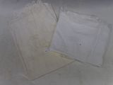 two pieces of white clothing on a white surface