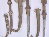 several different types of knives are displayed on a white surface