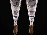 a pair of etched glass goblets with gold accents