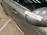 a sticker on the door of a car that is parked in a parking lot