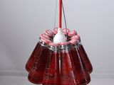 a red liquid bottle with a candle inside of it