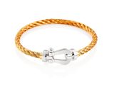 a gold braid bracelet with a silver clasp on a white background