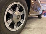 a close up view of a car ' s tire on the ground