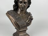 a bronze bust of a woman with a hat on her head