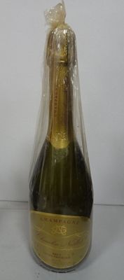 a bottle of champagne wrapped in plastic on a table