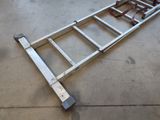 a metal ladder that is laying on the ground