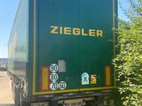 a green truck that is driving down the road