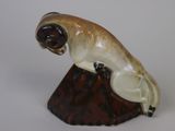 a figurine of a seal on a wooden base