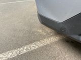 a close up of a car ' s bumper with a dent in it