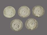 four silver coins with heads of women and men on them