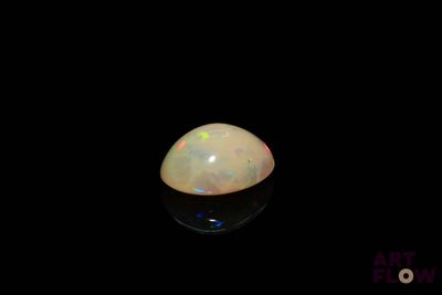 a close up of a white oplite on a black surface