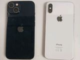 two iphones are sitting side by side on a table
