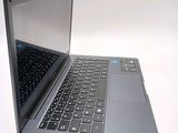 a silver laptop with a black keyboard on a white surface