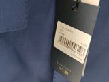 a close up of a blue shirt with a tag on it