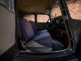a black car with a blue seat cover in the back of it