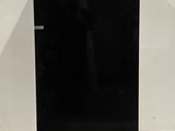 two black refrigerators sitting side by side in a room