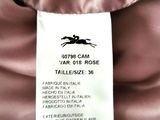the label of a pink dress with a black horse on it