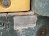 a close up of a yellow and green truck with rust
