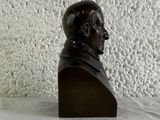 a bust of a man sitting on a table