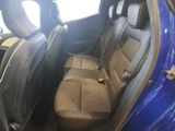 a blue car that is sitting in the back of the car