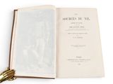 an open book with a gold handle on top of it