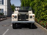 a white land rover parked on the side of the road
