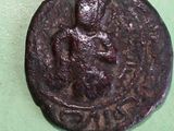 an old coin with a man on it on a green surface