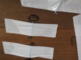 several pieces of paper taped to a piece of wood