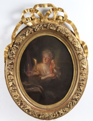 an old picture of a woman reading a book in a gold frame
