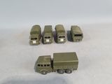 four toy army vehicles and a truck on a white surface