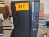 a desktop computer sitting on a desk in front of a phone