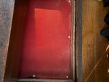 a red table with a red cover in a room