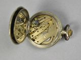 a pocket watch that is sitting on a table