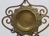a gold plate with a decorative design on top of it