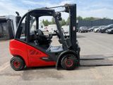 a red fork truck that is parked in a parking lot