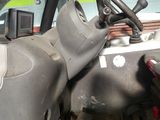 a truck that has a steering wheel in the back of it