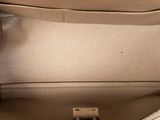the inside of a beige bag with a zipper on it