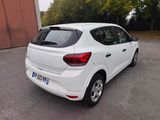 the rear end of a white car parked in a parking lot